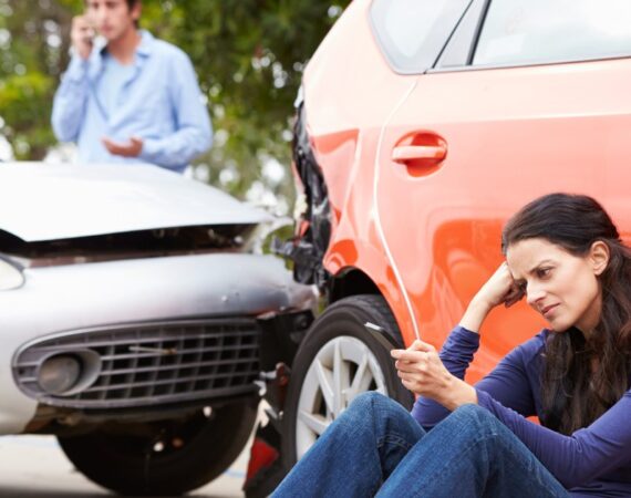 Car accident scene with an upset woman.